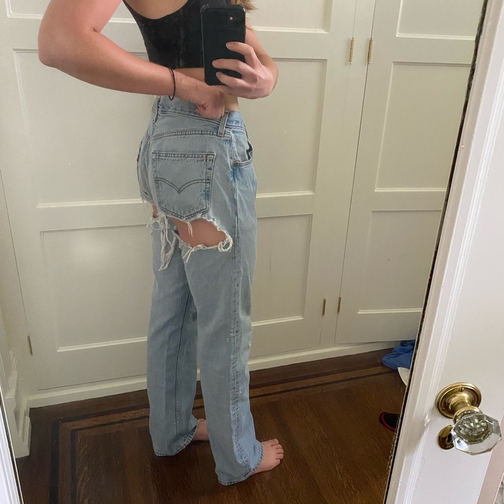 Light blue Levi jeans with large rips in the back